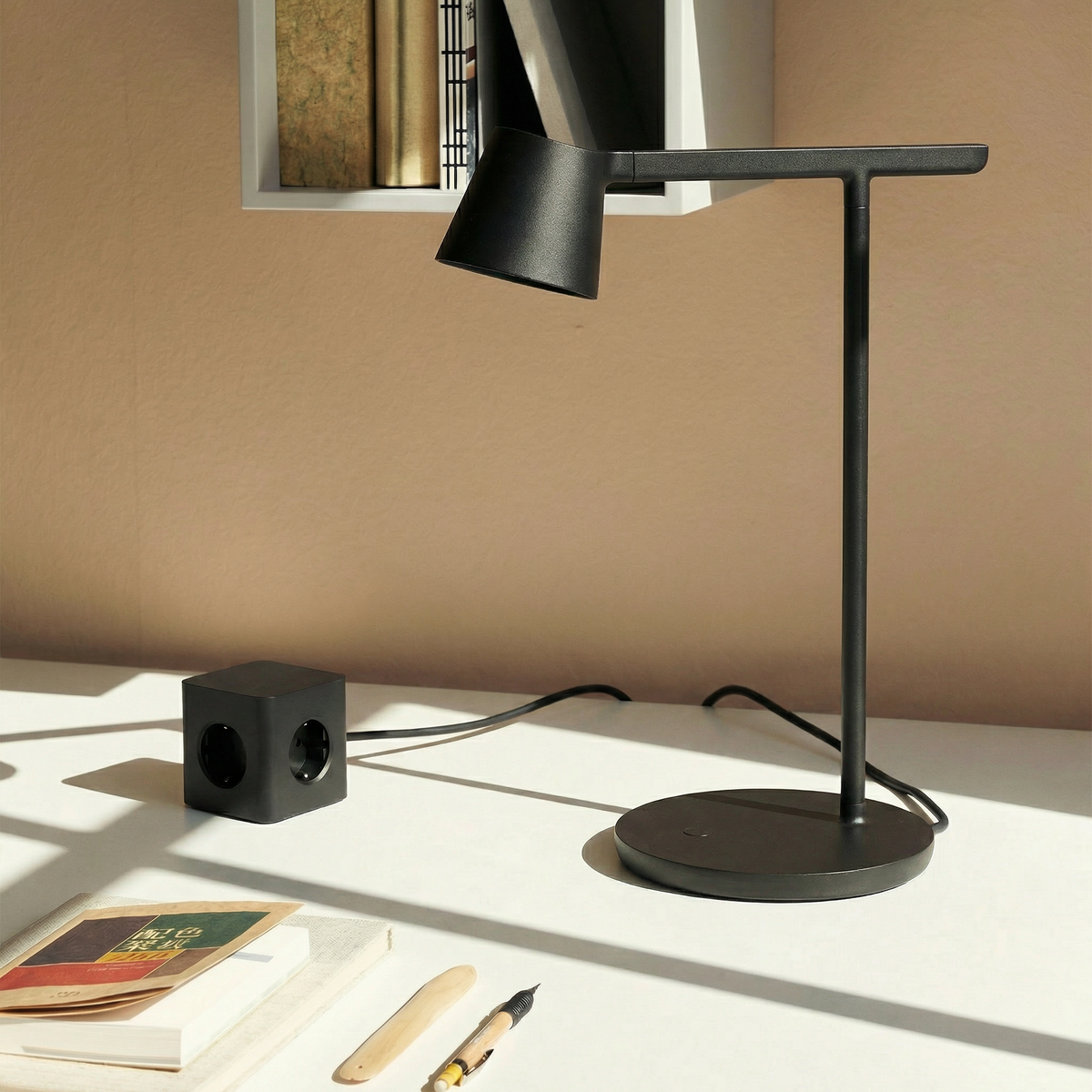 Cords® Cubical C1 Jet Black on a home desk.