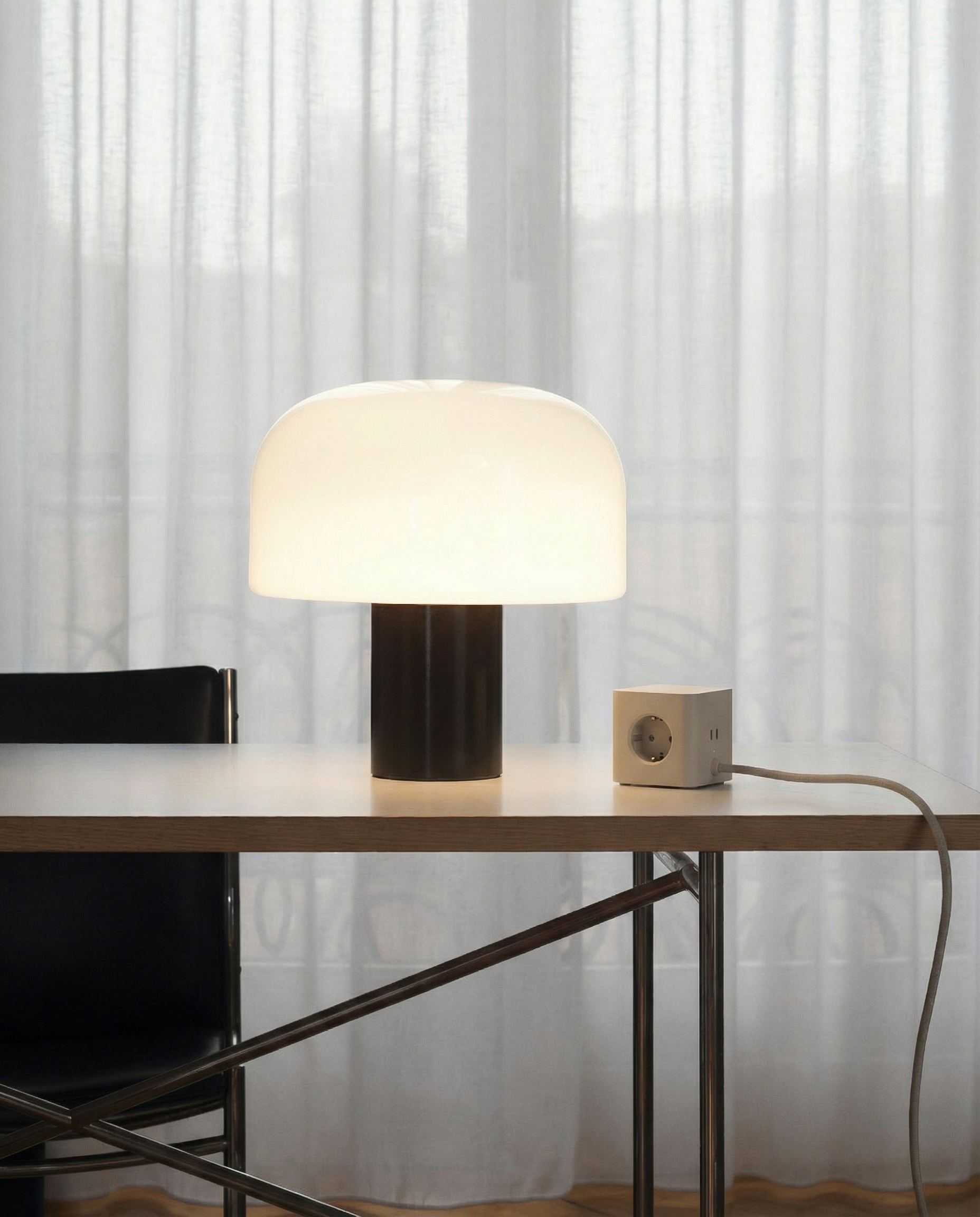 Cords® Cubical C1 Sand on a table with a white curtain background