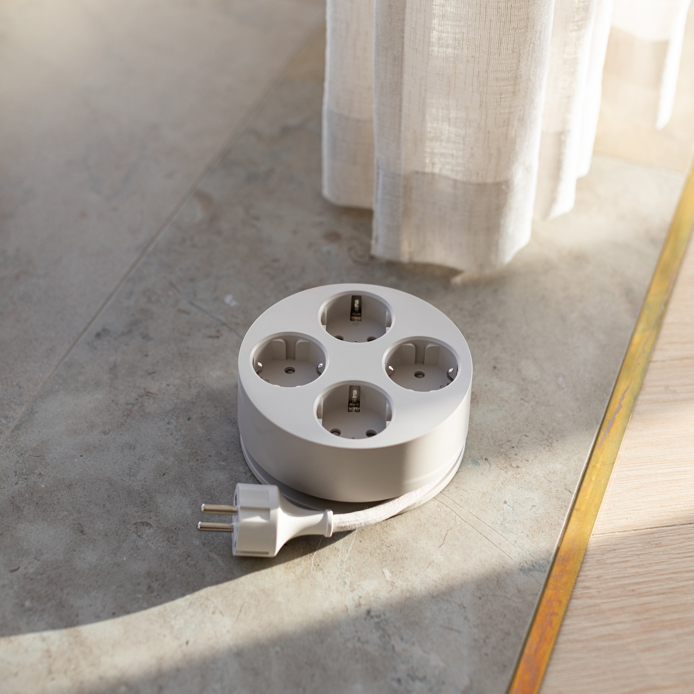 Cords Circular C2 in Sand on the floor in sunlight