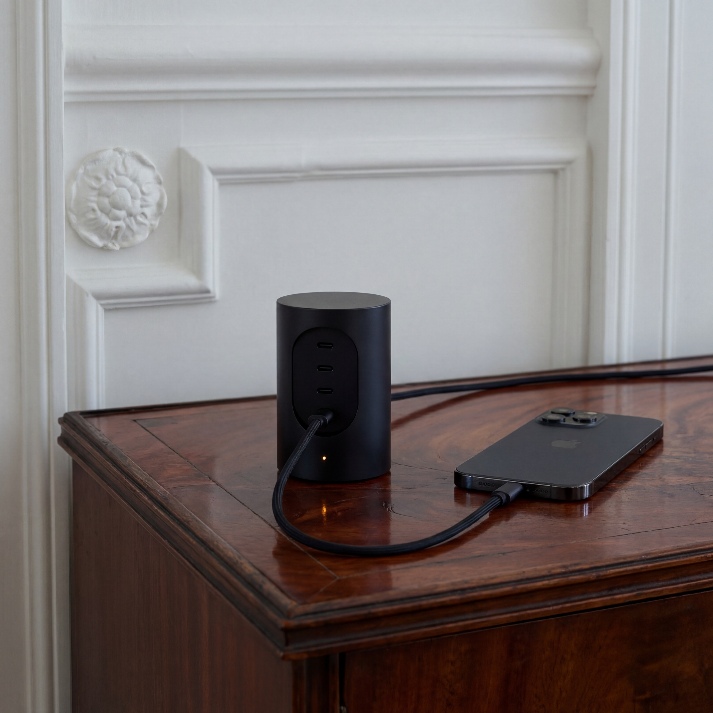 Cords Cylindric UX1 in Jet Black on a sideboard